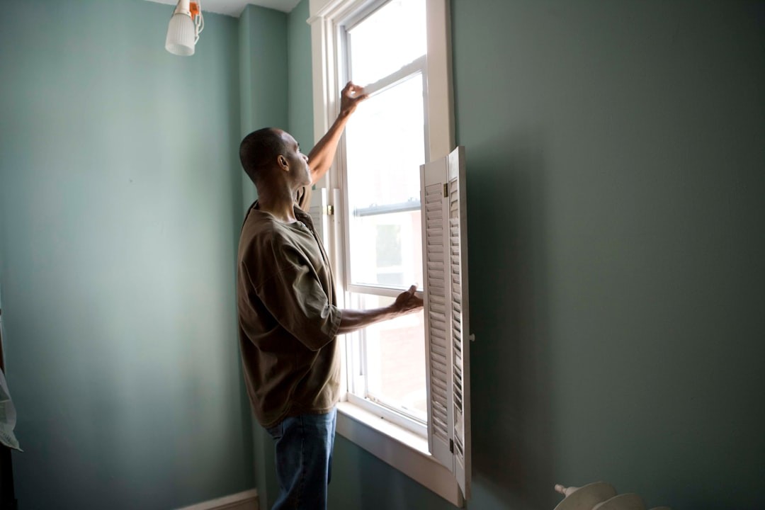 When renovating a home, you should use a damp sponge or cloth to clean dust collected on a window sill, as the dust may contain asbestos or lead-based paint. Home maintenance is an ongoing process for any homeowner, and here we see an African-American man as he was preparing a window in his home for a general cleaning.